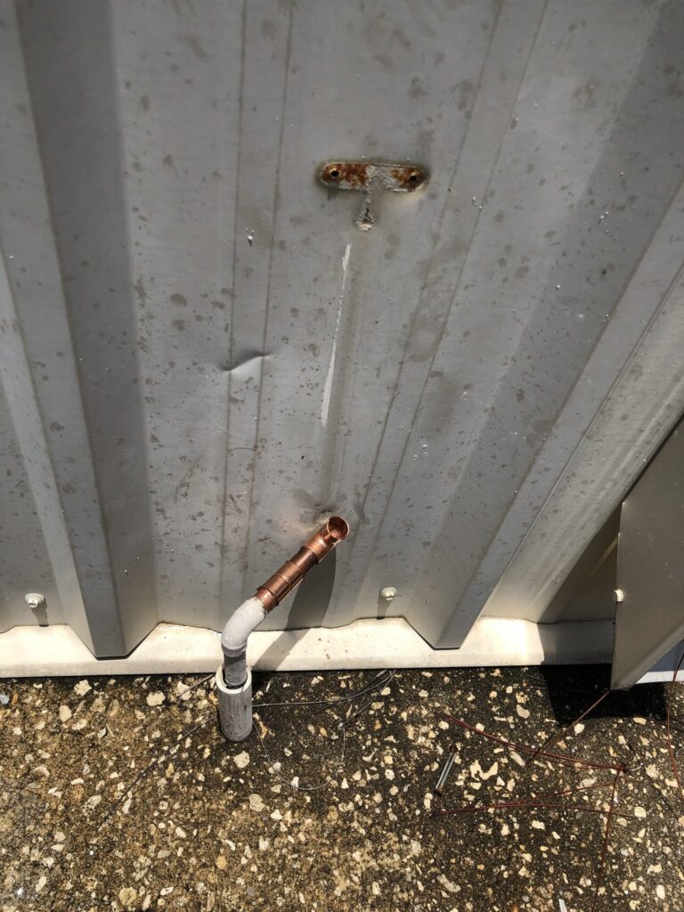Old pipe stub through a block wall at a Palm Coast home