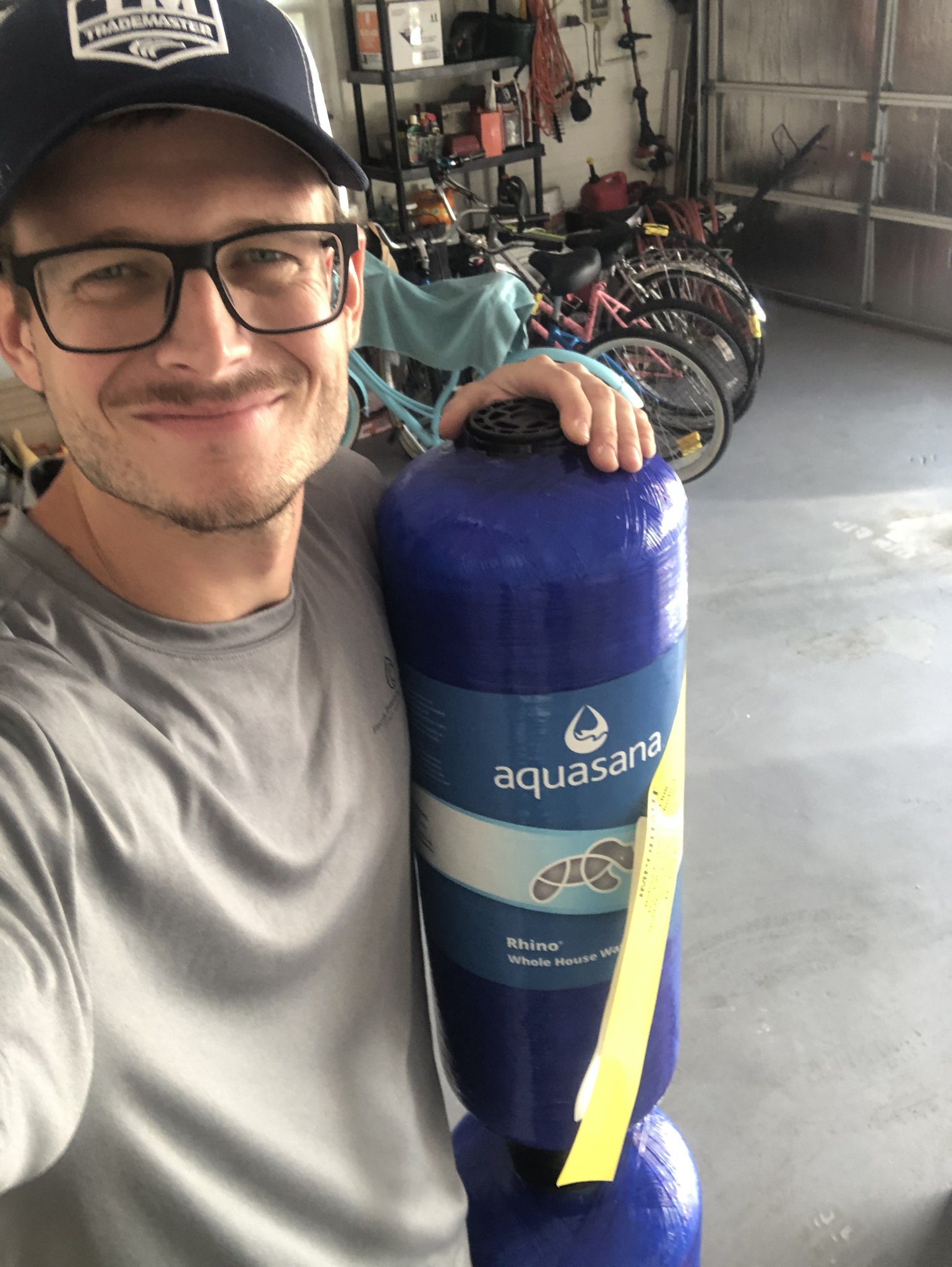 Christian Laymon, master plumber and owner of Florida Plumbing & Inspection, holding an Aquasana filtration tank before an install in Palm Coast