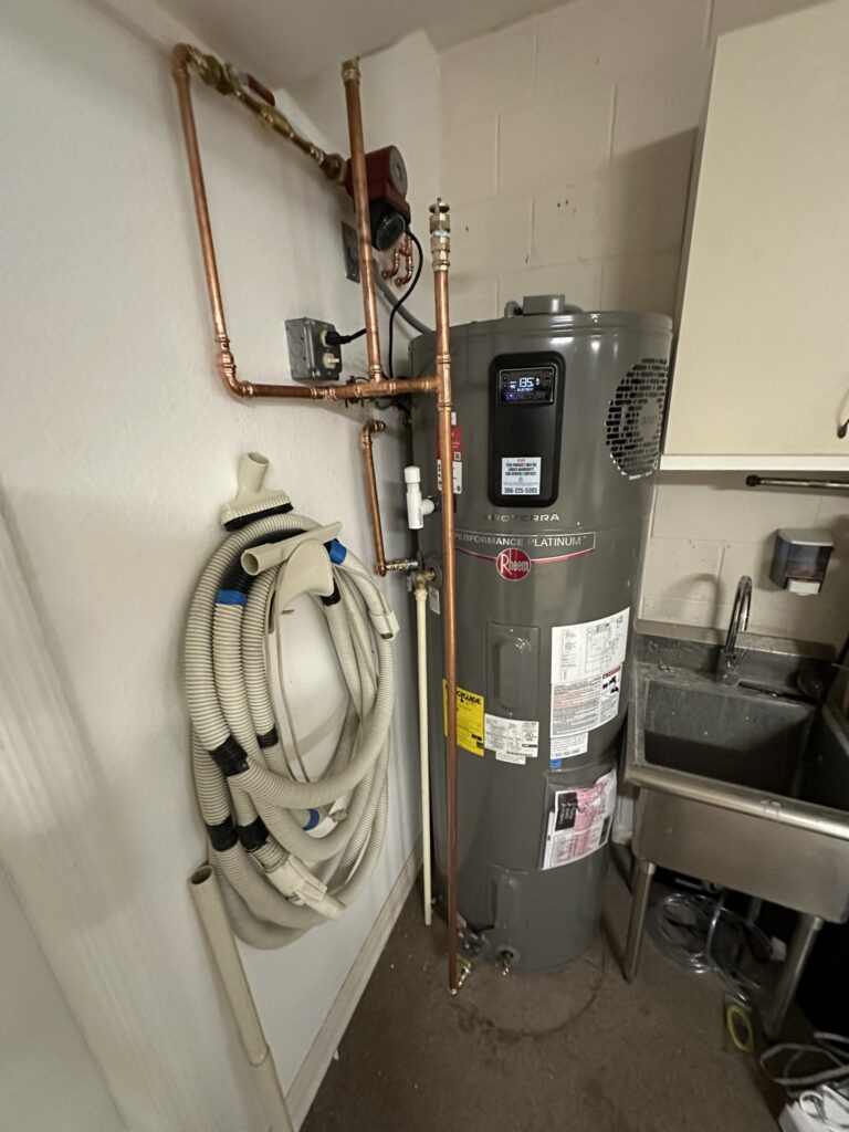 Rheem electric water heater installed in a Palm Coast garage