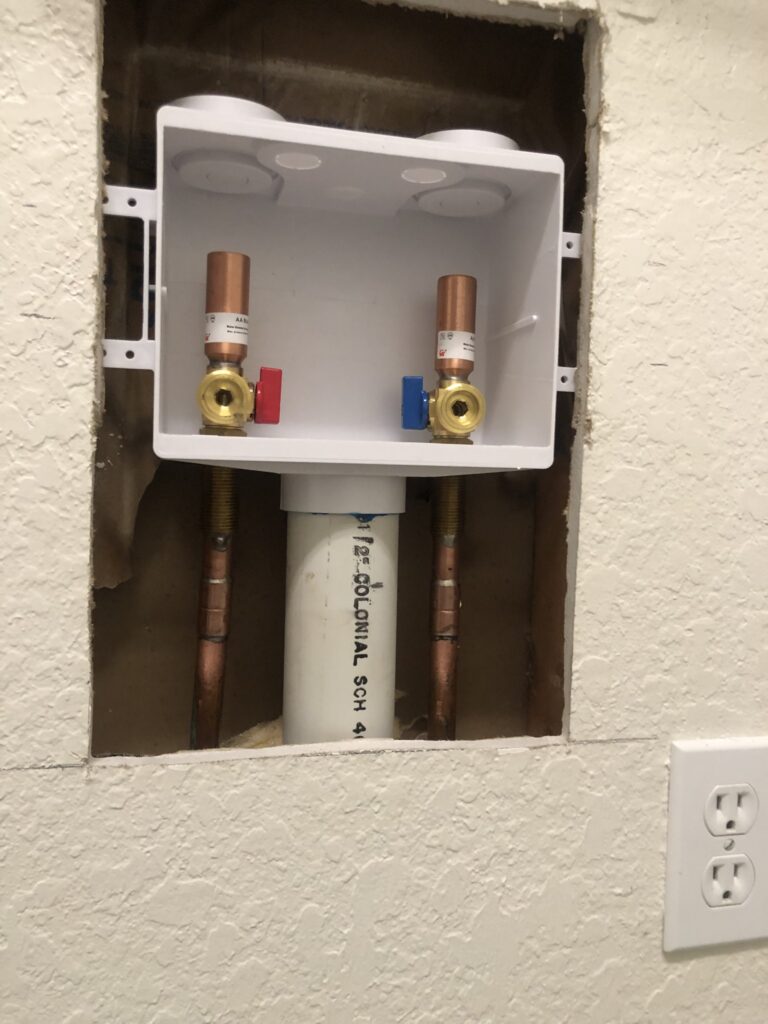 New PEX supply lines and washer box installed during a Palm Coast repipe