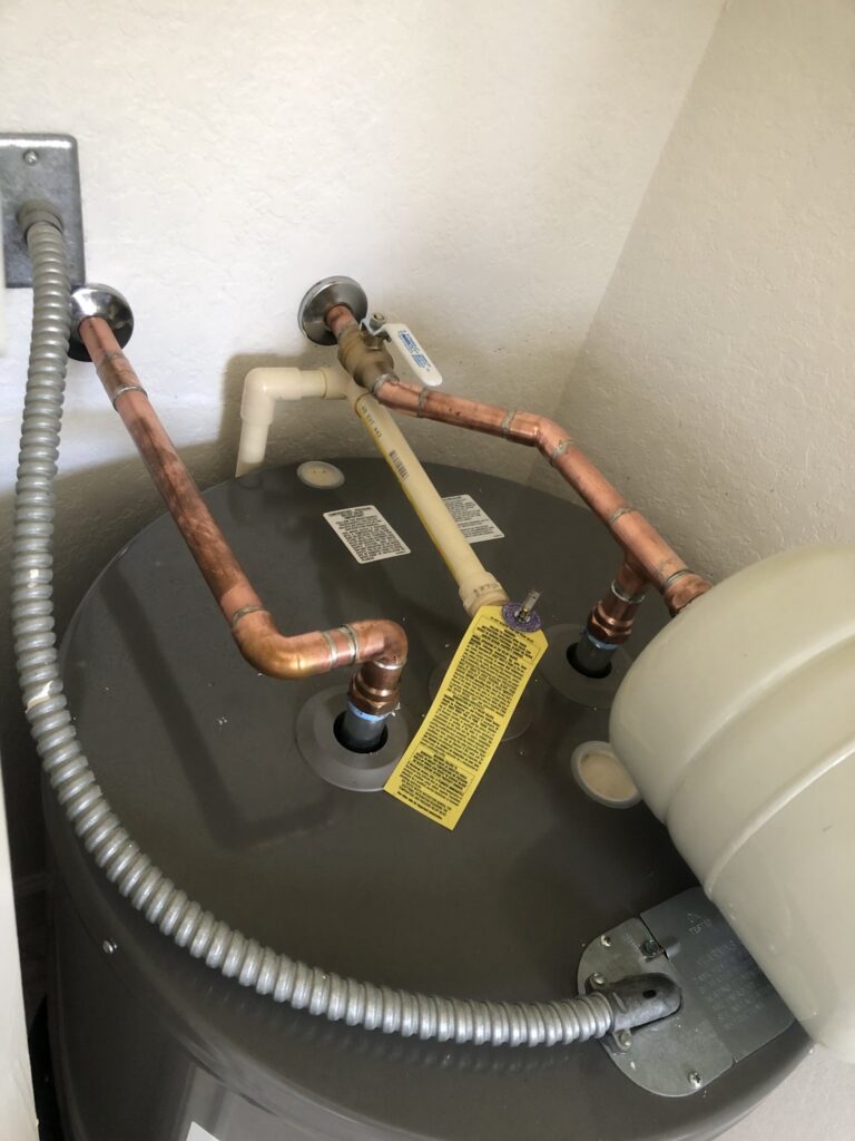 Corrugated supply connectors on top of an older electric water heater