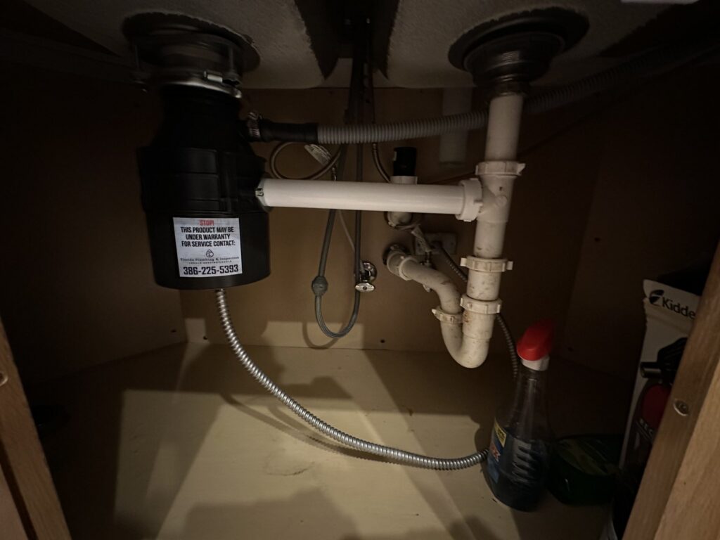 New garbage disposal installed under a kitchen sink in Palm Coast