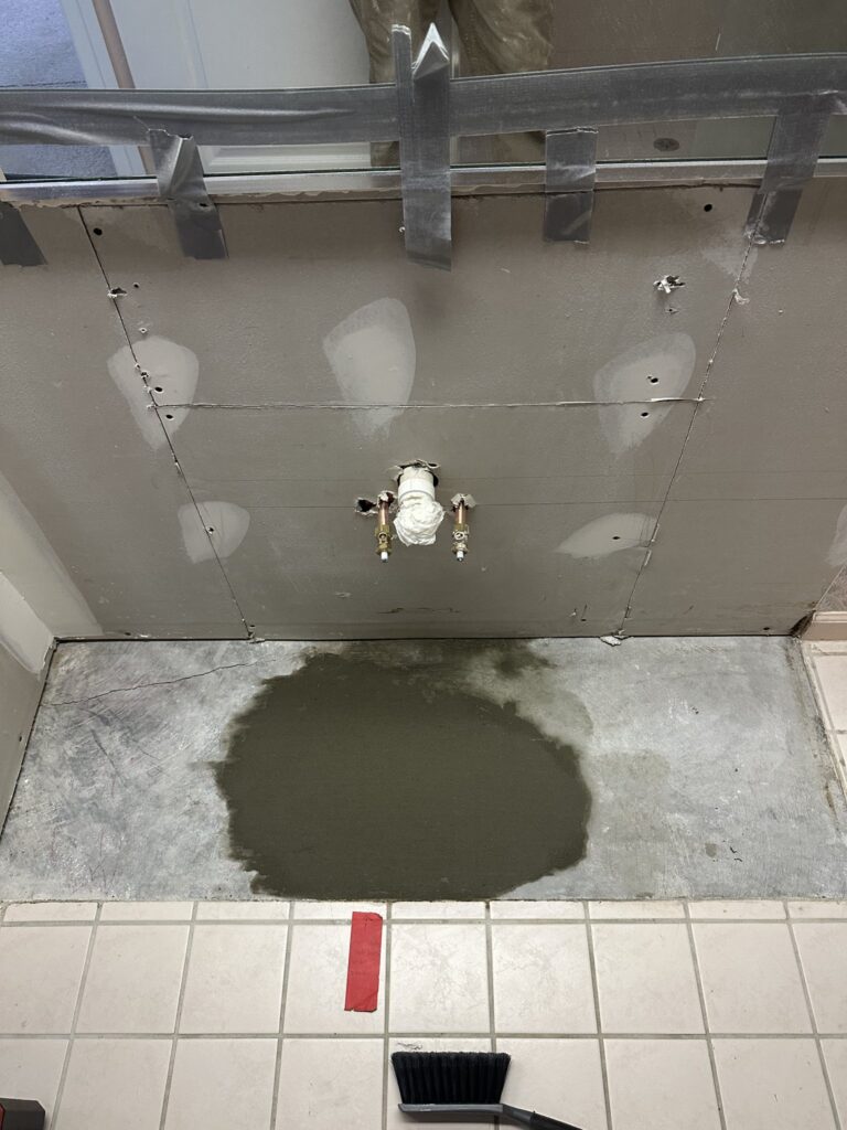 Concrete poured back over a relocated drain in a Palm Coast bathroom