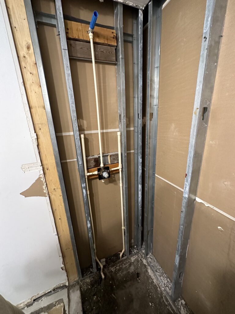 Bathroom rough-in plumbing in open stud walls awaiting inspection in Palm Coast