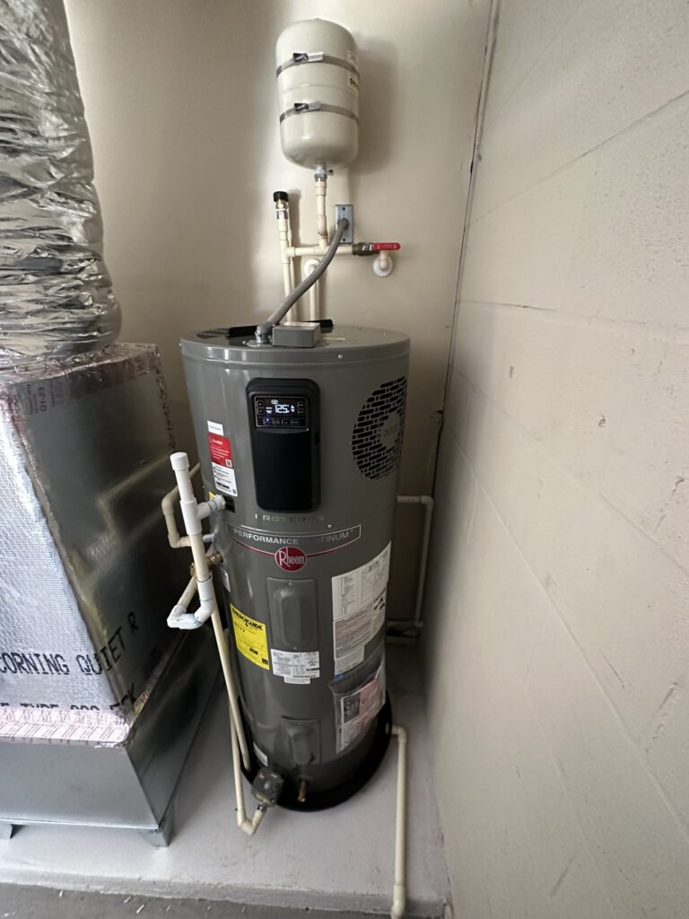 Rheem hybrid water heater with copper lines and expansion tank in a Palm Coast garage
