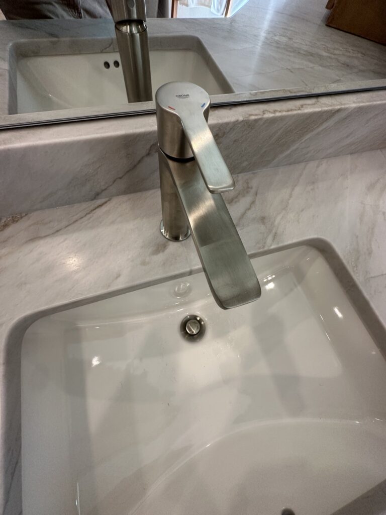 Widespread vanity faucet on a marble countertop in Palm Coast