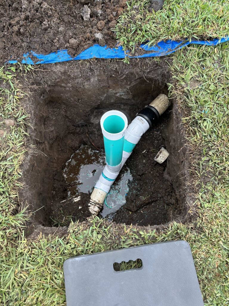 PVC sewer fitting exposed in an excavation in Palm Coast