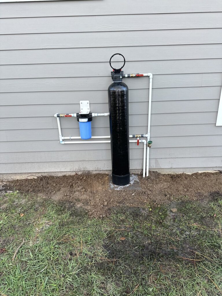 Well water filter and pressure system mounted on an exterior wall in Flagler County