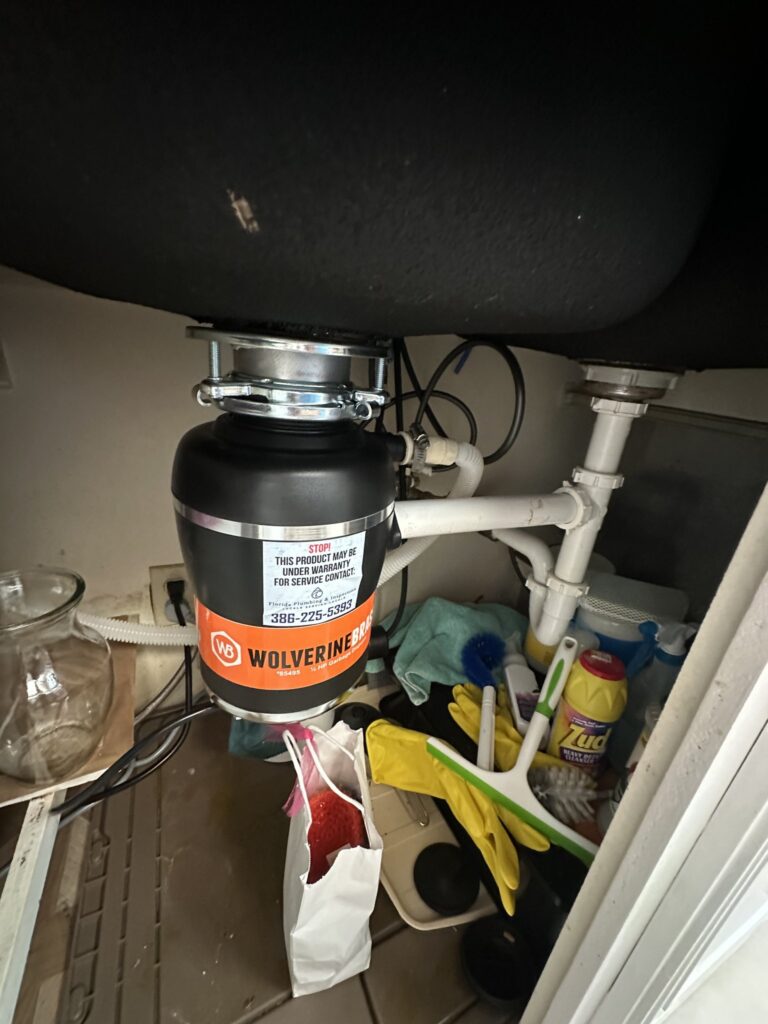 Garbage disposal and drain plumbing under a Palm Coast kitchen sink
